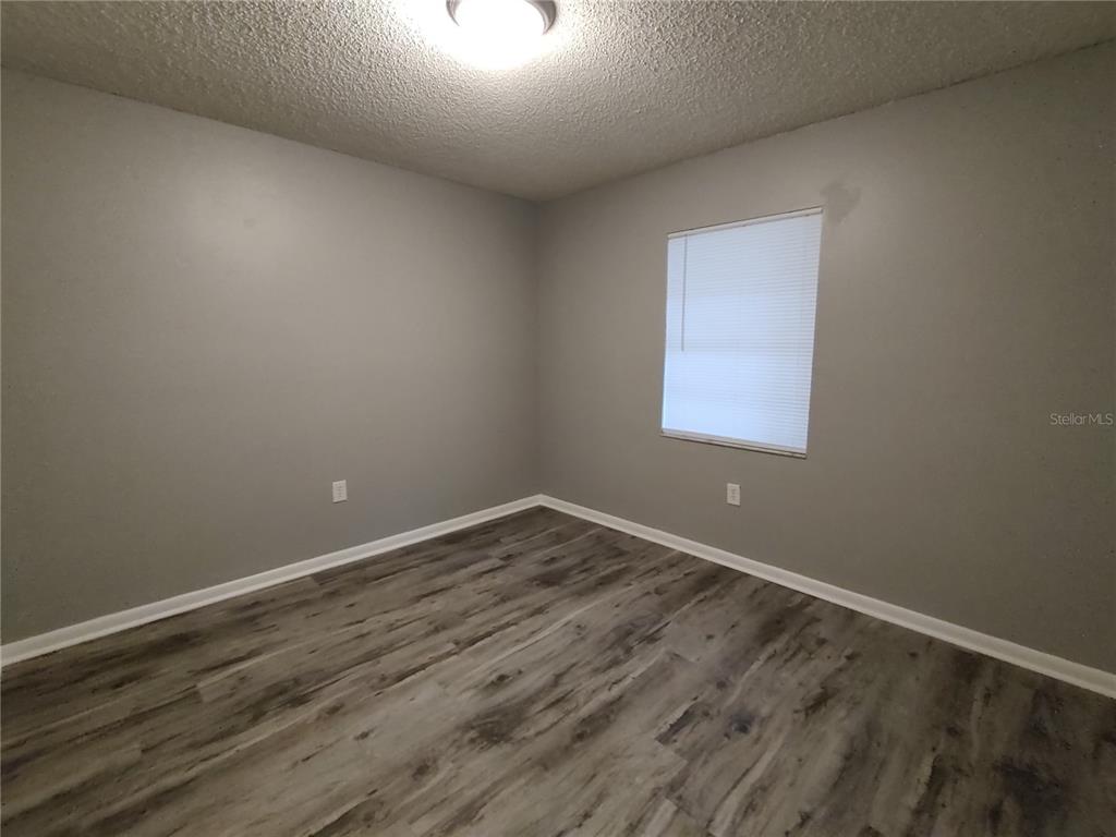 200 Church Street, Unit F2 Leesburg, FL 34748 - Photo 15 of 23 an empty room with wooden floor and windows