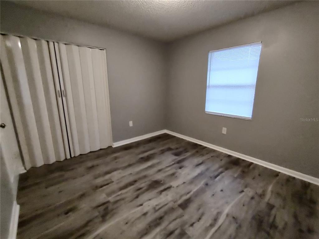 200 Church Street, Unit F2 Leesburg, FL 34748 - Photo 21 of 23 a view of a room with wooden floor and a window