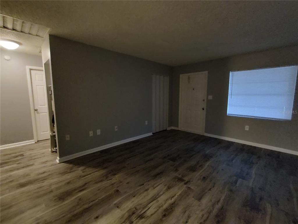 200 Church Street, Unit F2 Leesburg, FL 34748 - Photo 7 of 23 a view of an empty room with wooden floor and a window