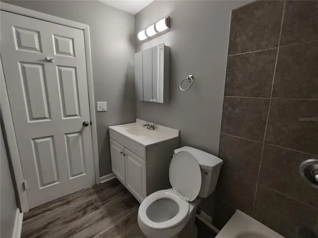 a bathroom with a toilet mirror vanity and toilet