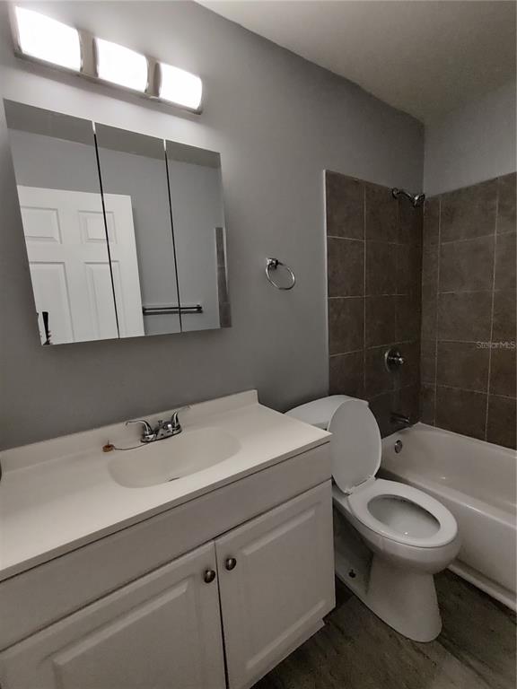 200 Church Street, Unit F2 Leesburg, FL 34748 - Photo 9 of 23 a bathroom with a sink a toilet and shower