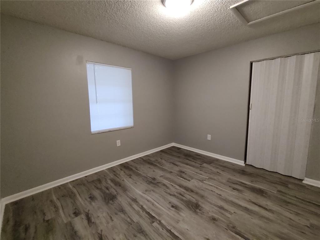 200 Church Street, Unit F2 Leesburg, FL 34748 - Photo 10 of 23 a view of an empty room with wooden floor and a window