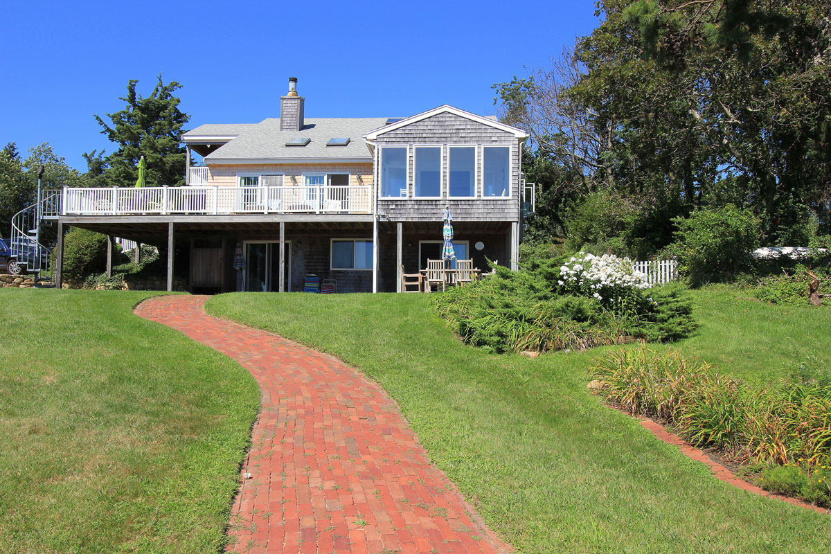 95 Hines Point Road Vineyard Haven, MA 02568 - Photo 1 of 43 a front view of a house with a yard