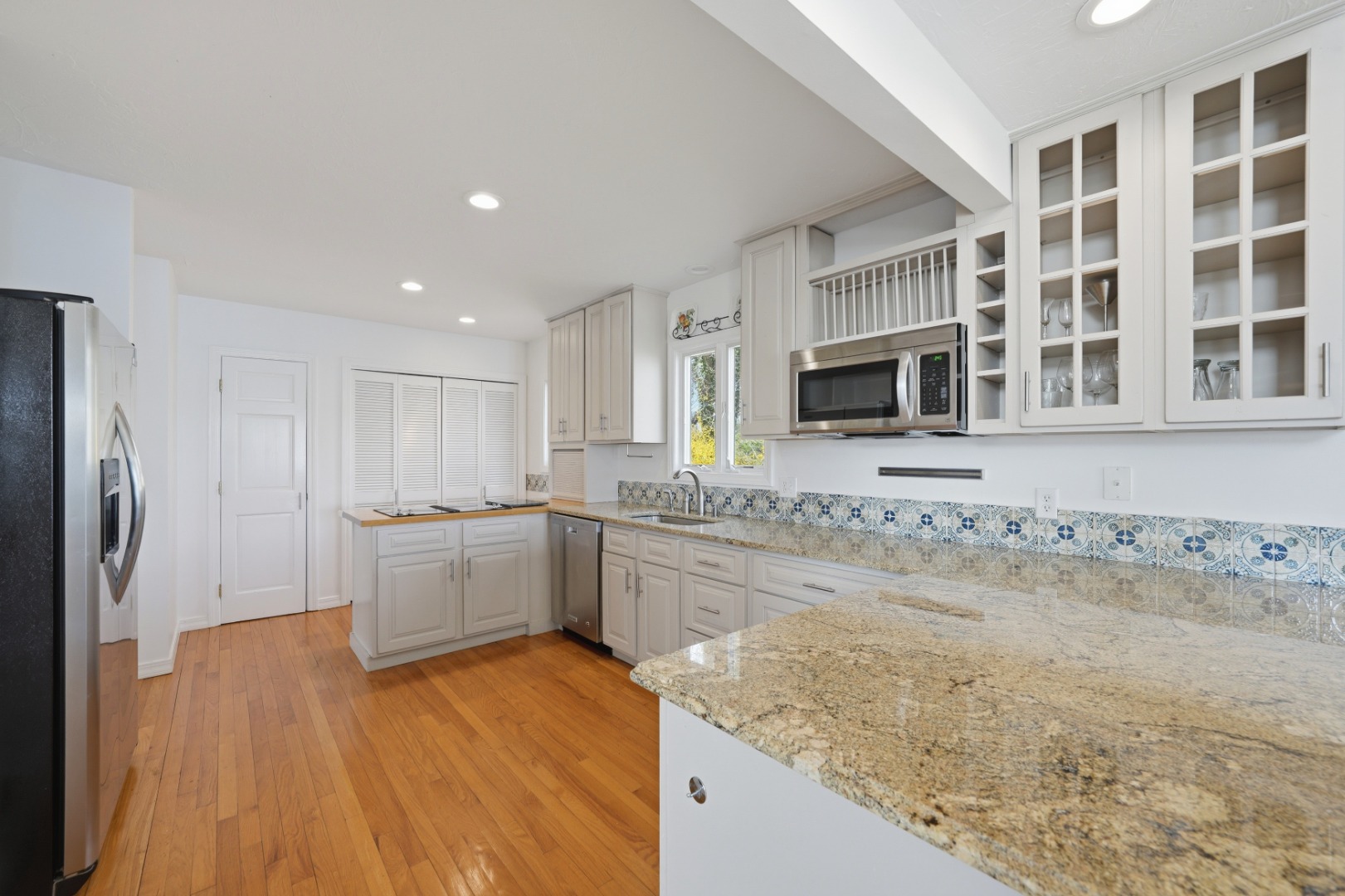 95 Hines Point Road Vineyard Haven, MA 02568 - Photo 12 of 36 a large kitchen with granite countertop a sink stainless steel appliances and cabinets