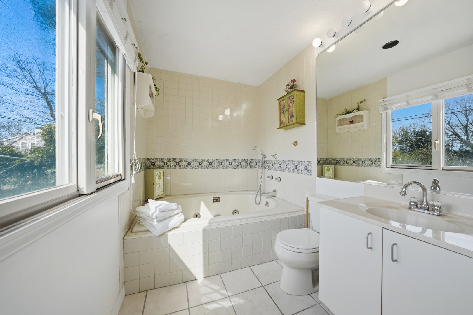 95 Hines Point Road Vineyard Haven, MA 02568 - Photo 20 of 36 a bathroom with a granite countertop sink a toilet tub and mirror