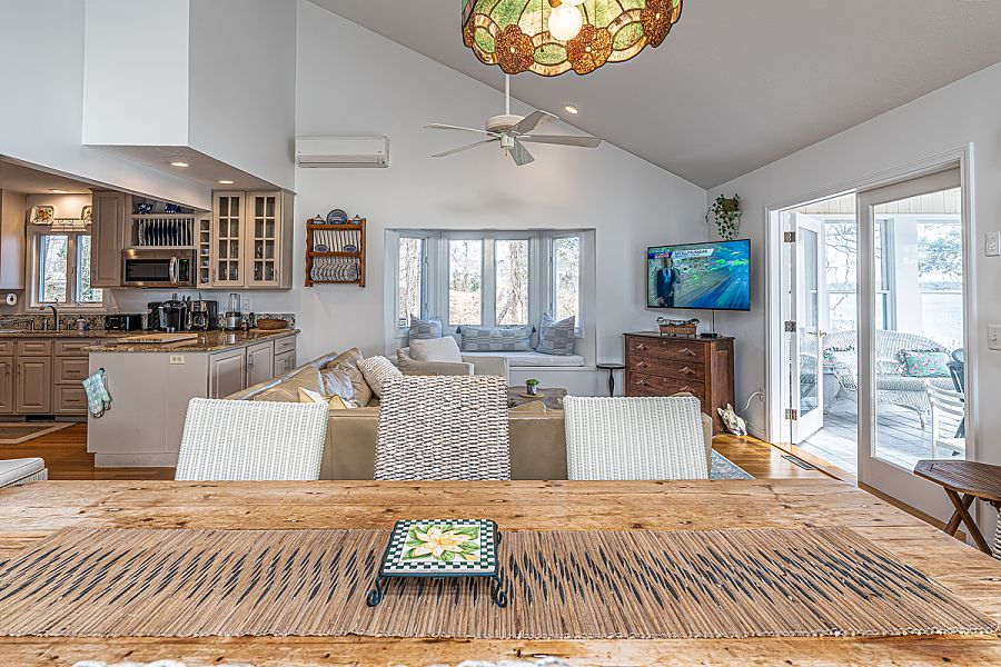 95 Hines Point Road Vineyard Haven, MA 02568 - Photo 21 of 43 a living room with furniture a flat screen tv and a large window