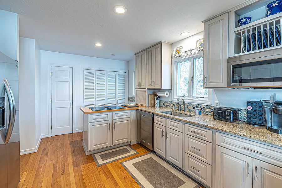 95 Hines Point Road Vineyard Haven, MA 02568 - Photo 24 of 43 a kitchen with a sink stove and cabinets