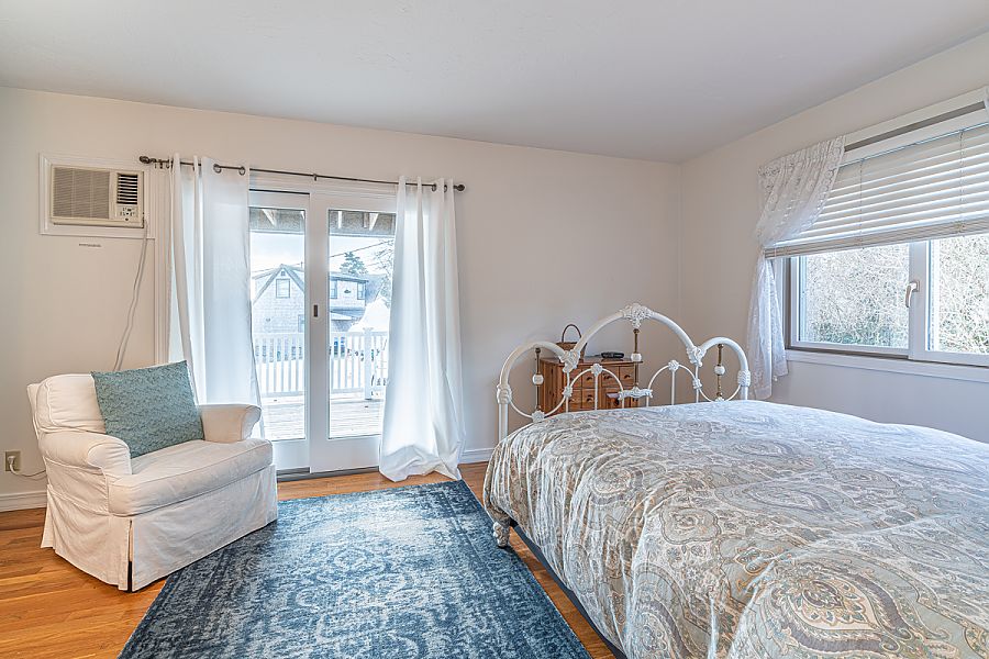 95 Hines Point Road Vineyard Haven, MA 02568 - Photo 25 of 43 a bedroom with a large bed couch and a window