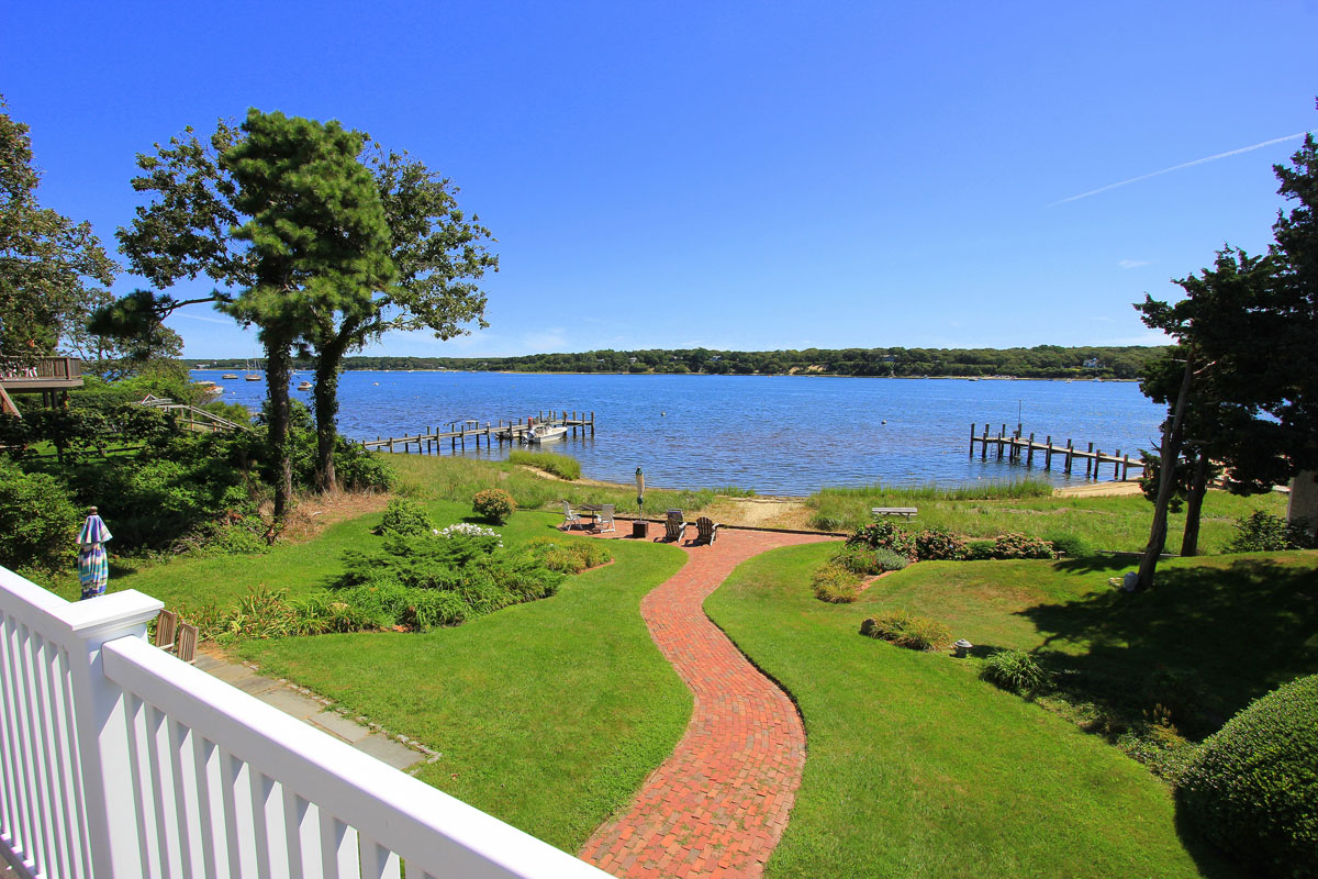 95 Hines Point Road Vineyard Haven, MA 02568 - Photo 3 of 43 a view of a swimming pool with a lake view