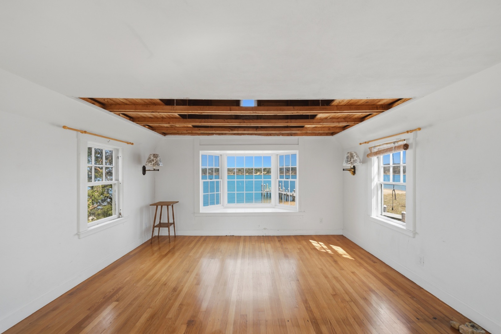 95 Hines Point Road Vineyard Haven, MA 02568 - Photo 33 of 36 an empty room with wooden floor and windows