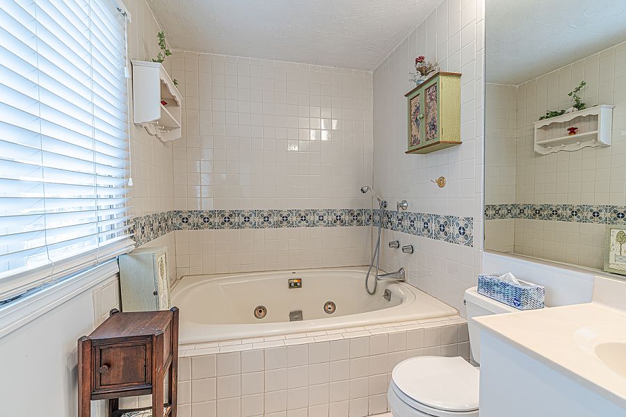 95 Hines Point Road Vineyard Haven, MA 02568 - Photo 35 of 43 a white bath tub sitting next to a white toilet