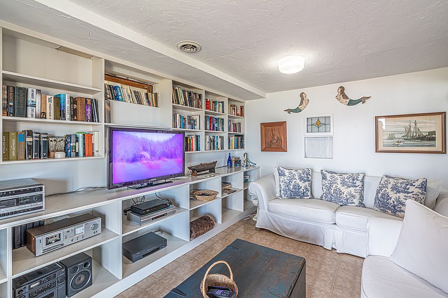 95 Hines Point Road Vineyard Haven, MA 02568 - Photo 40 of 43 a living room with furniture cabinets and a window