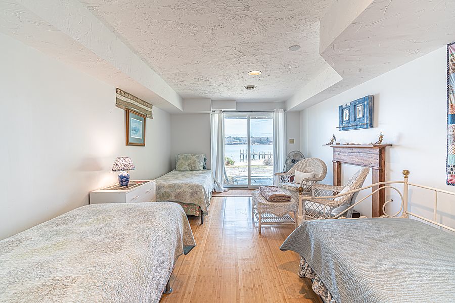 95 Hines Point Road Vineyard Haven, MA 02568 - Photo 41 of 43 a bedroom with a bed and glass windows