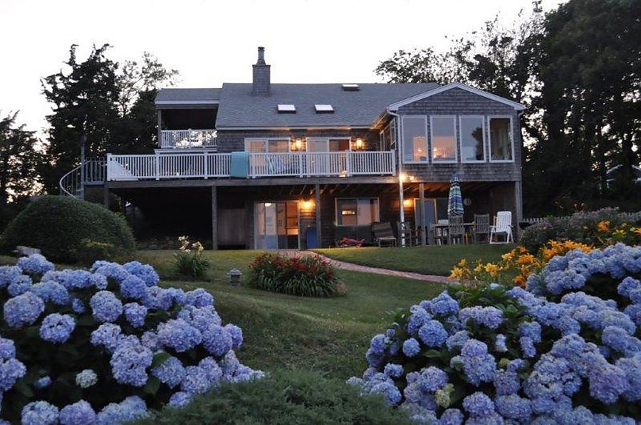 95 Hines Point Road Vineyard Haven, MA 02568 - Photo 43 of 43 a front view of a house with lots of flower and trees