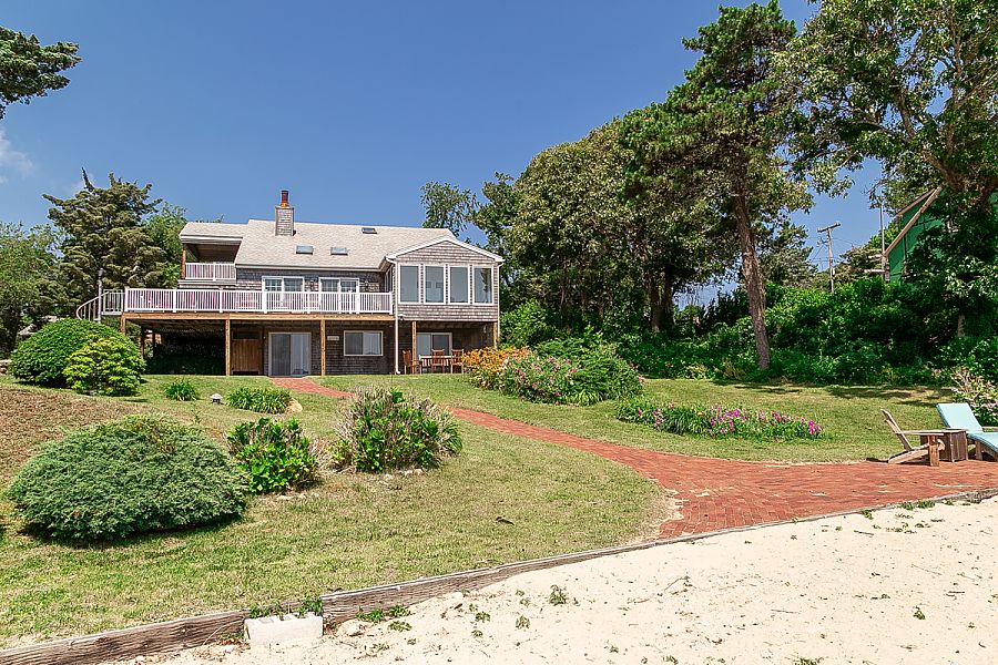 95 Hines Point Road Vineyard Haven, MA 02568 - Photo 5 of 43 a front view of a house with a yard