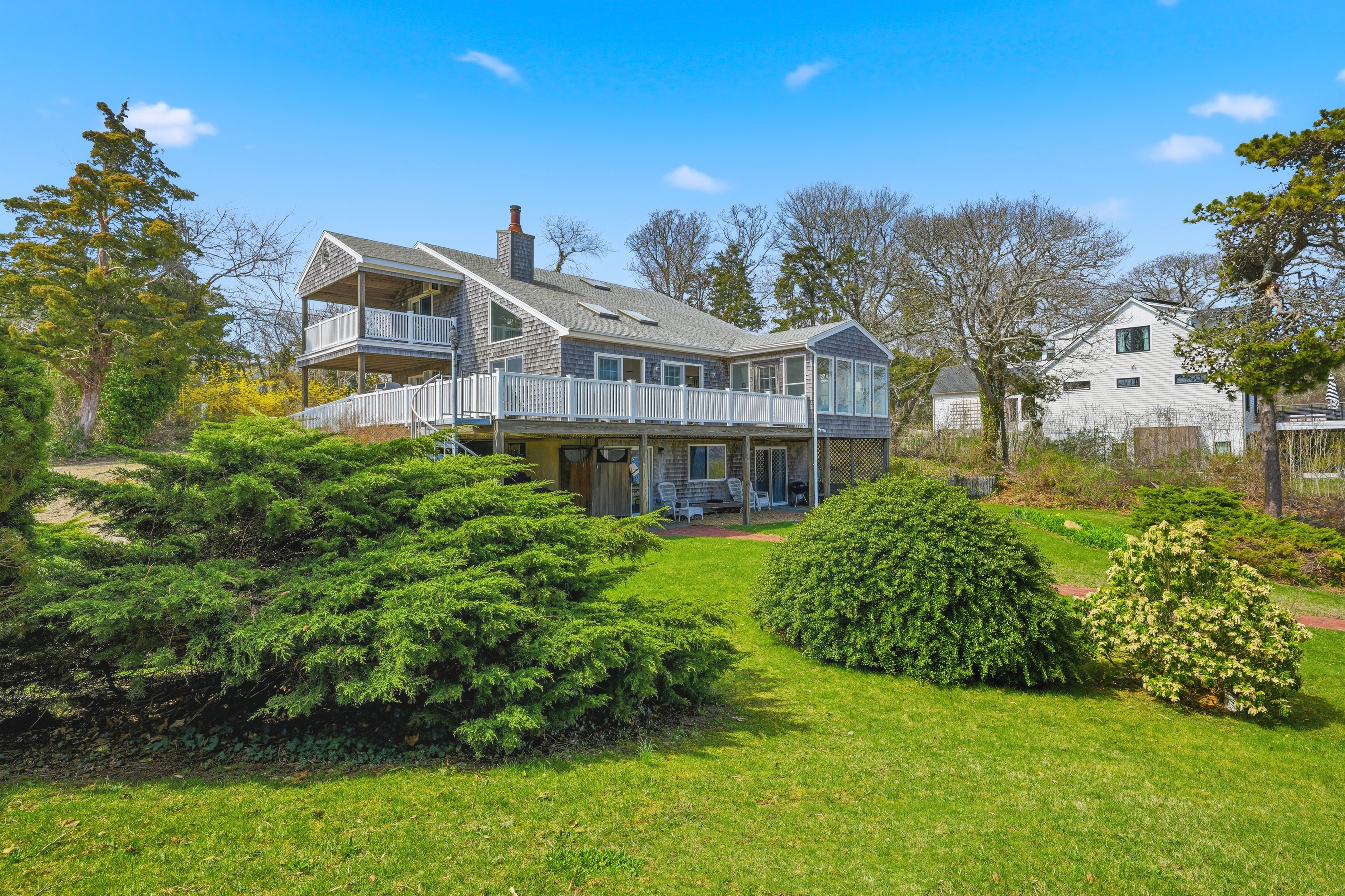 95 Hines Point Road Vineyard Haven, MA 02568 - Photo 5 of 36 a front view of a house with a garden