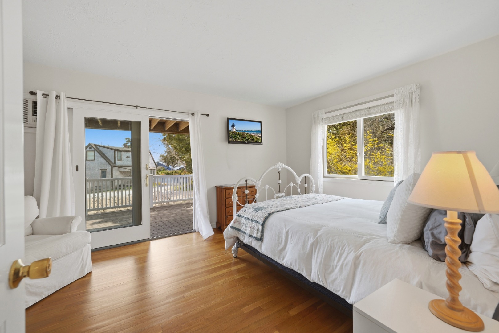 95 Hines Point Road Vineyard Haven, MA 02568 - Photo 9 of 36 a bedroom with a large bed and a lamp
