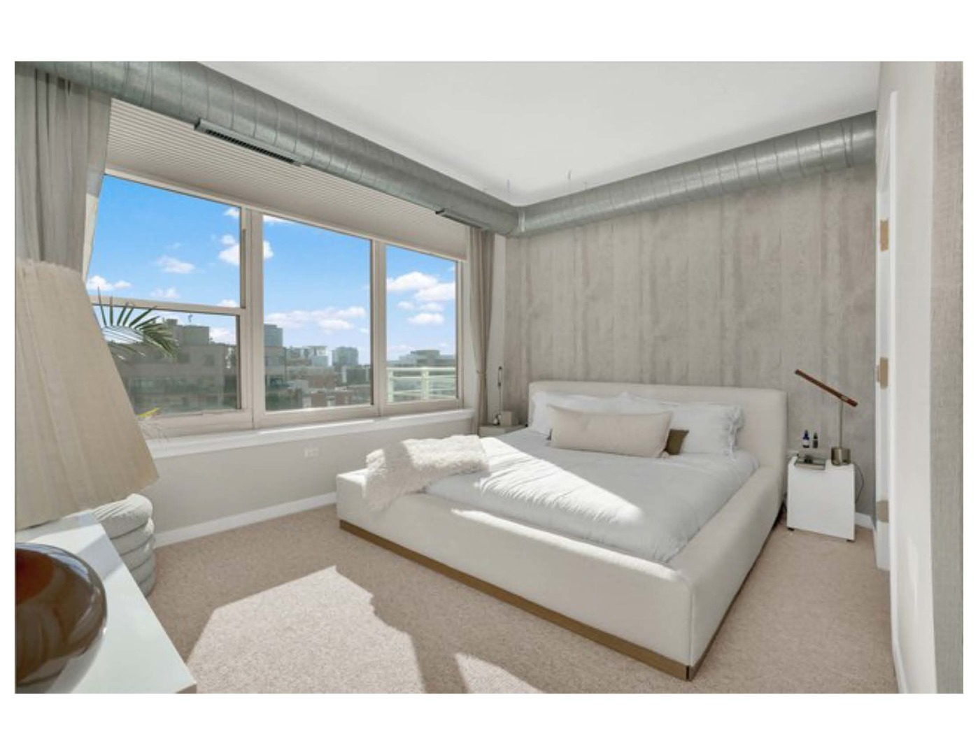 909 West Washington Boulevard, Unit 1002 Chicago, IL 60607 - Photo 11 of 15 a bedroom with a bed and a large window