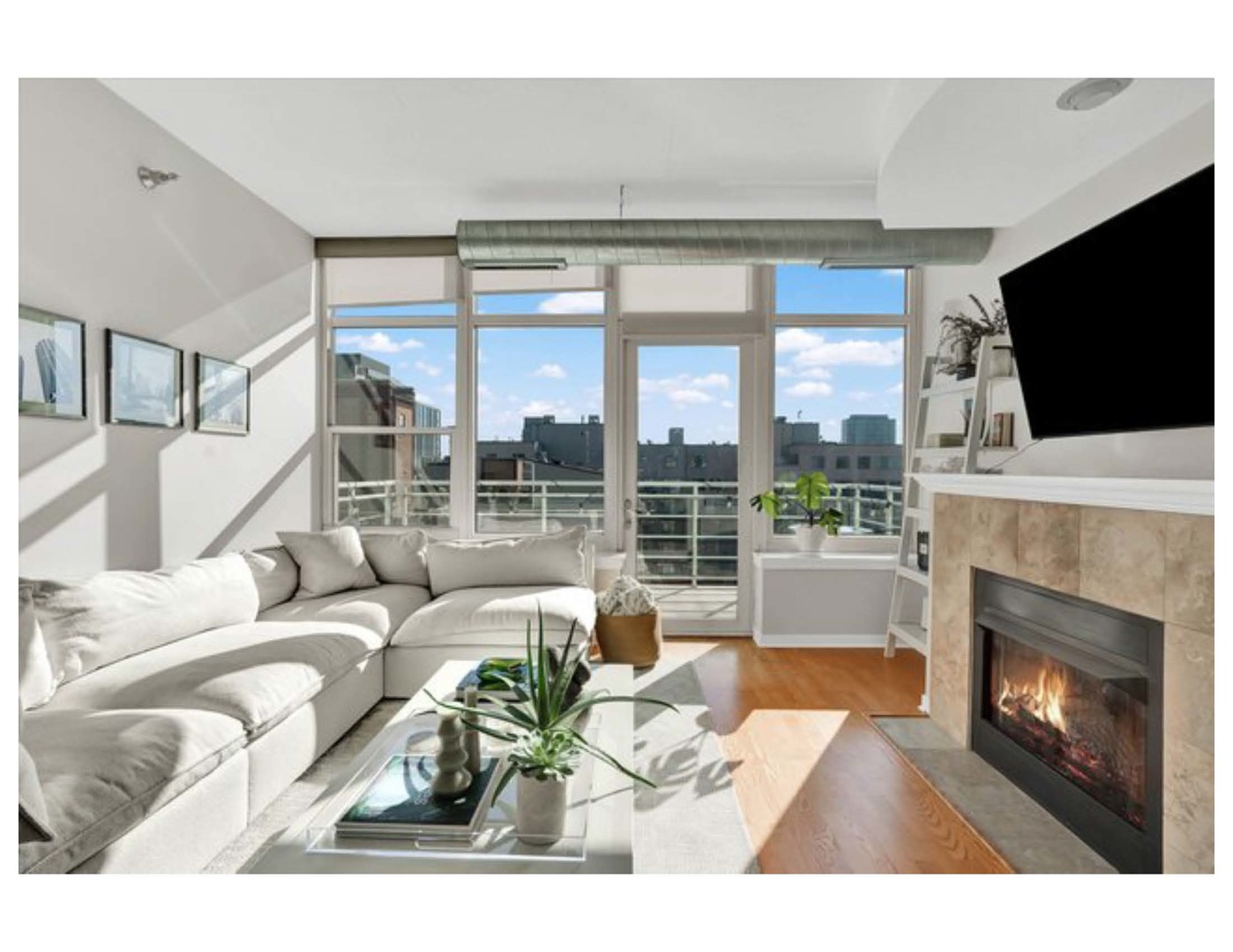 909 West Washington Boulevard, Unit 1002 Chicago, IL 60607 - Photo 8 of 15 a living room with furniture a fireplace and a flat screen tv