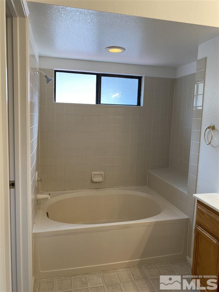 5236 Simons Drive Reno, NV 89523 - Photo 11 of 19 a white bath tub sitting next to a window