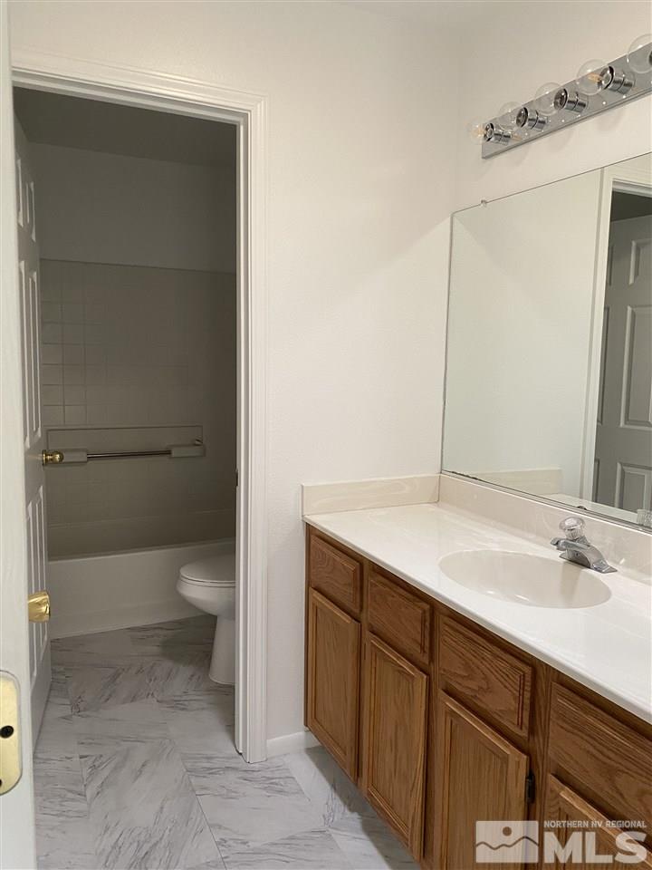 5236 Simons Drive Reno, NV 89523 - Photo 14 of 19 a bathroom with a sink toilet and shower
