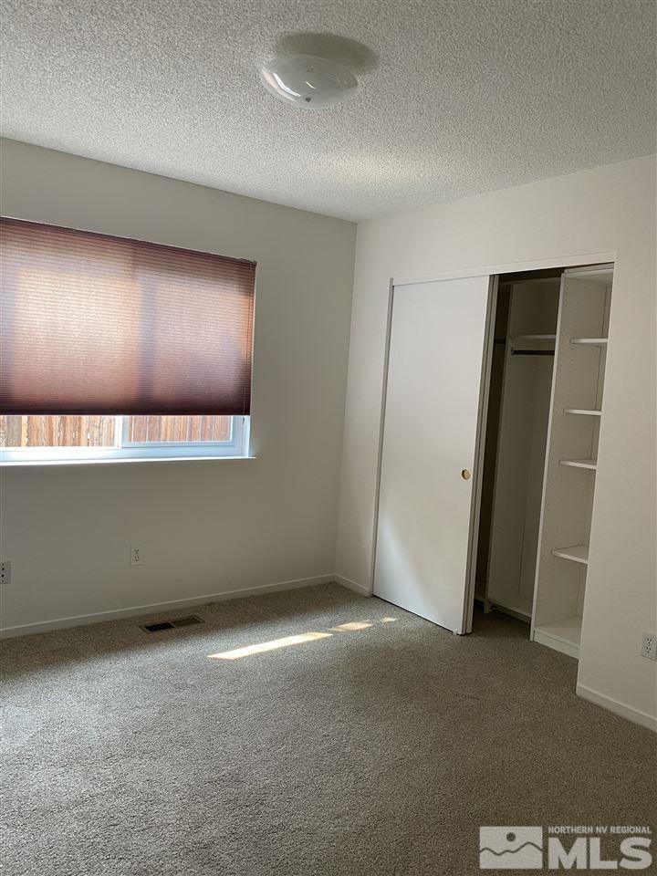 5236 Simons Drive Reno, NV 89523 - Photo 16 of 19 an empty room with wooden floor and windows