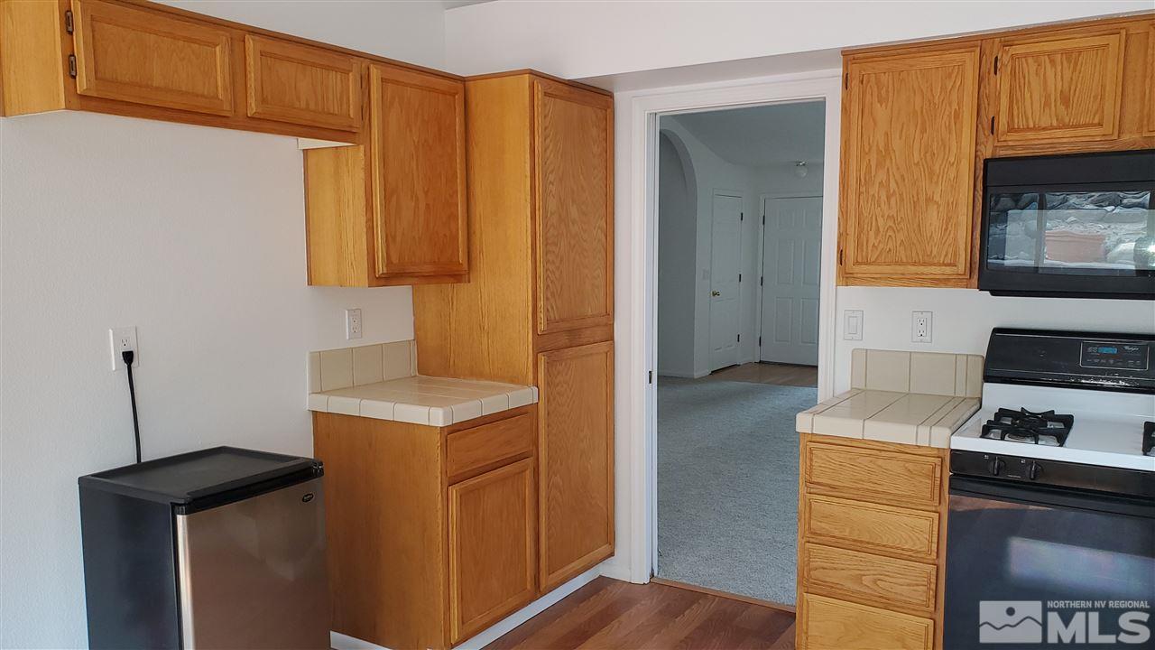 5236 Simons Drive Reno, NV 89523 - Photo 4 of 19 a kitchen with a stove and a refrigerator