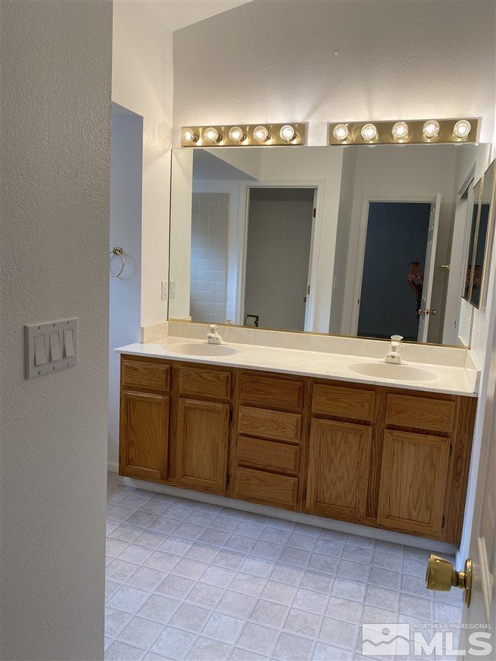 5236 Simons Drive Reno, NV 89523 - Photo 10 of 19 a bathroom with a granite countertop sink and a mirror