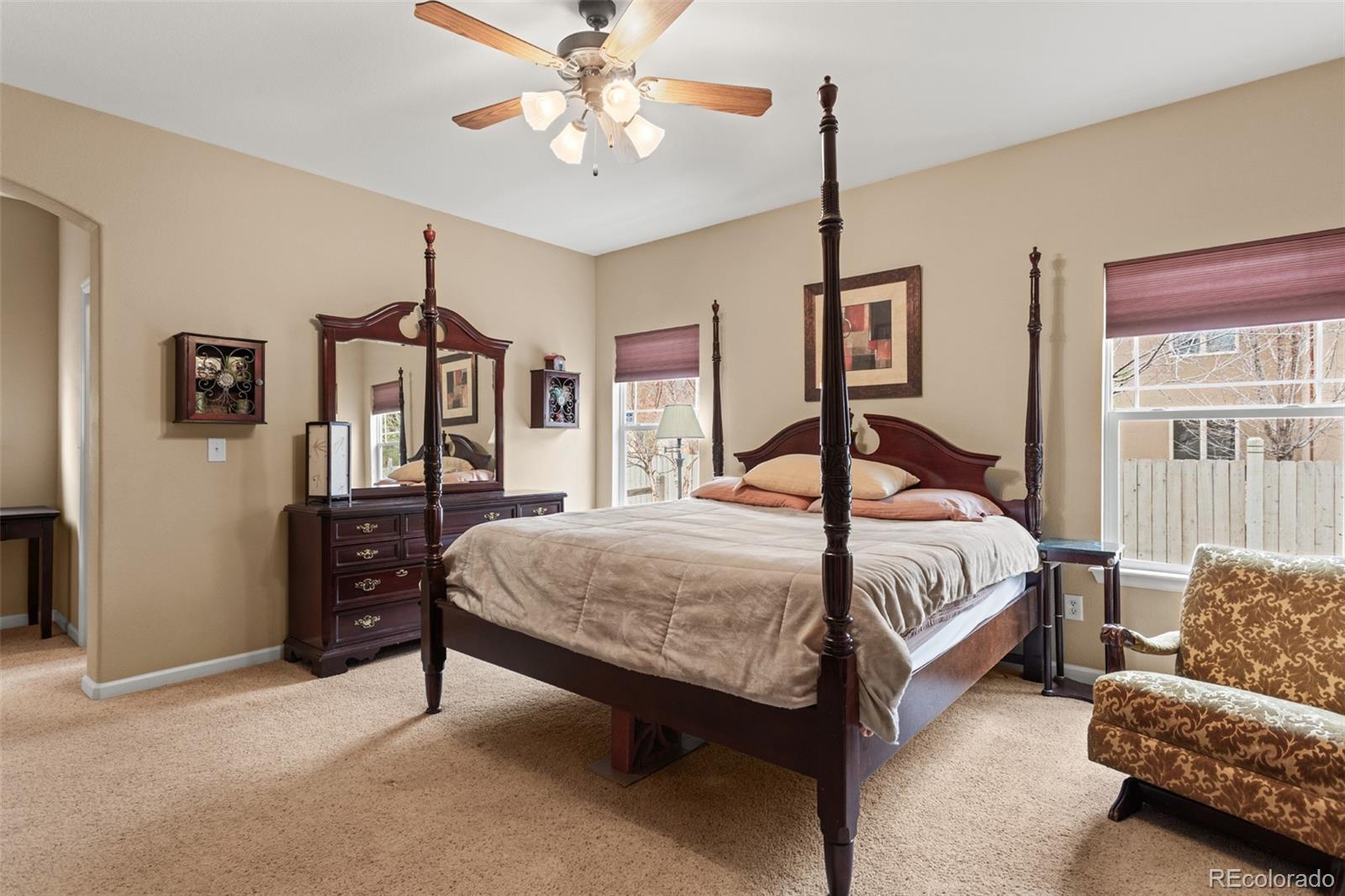 4207 Frederick Circle Longmont, CO 80503 - Photo 15 of 35 a bedroom with a bed and a chandelier