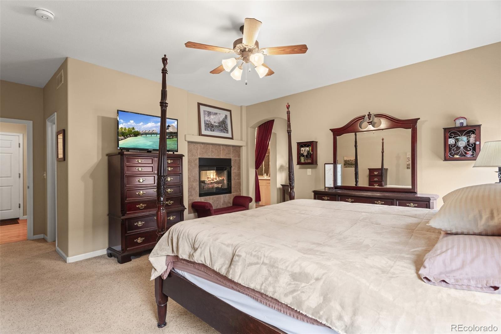 4207 Frederick Circle Longmont, CO 80503 - Photo 16 of 35 a bedroom with a bed and dresser with mirror