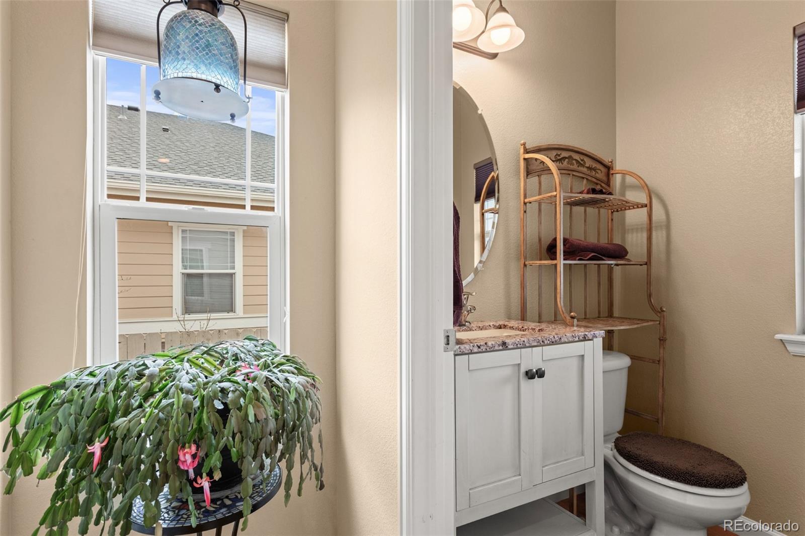 4207 Frederick Circle Longmont, CO 80503 - Photo 22 of 35 a bathroom with a sink a toilet and mirror