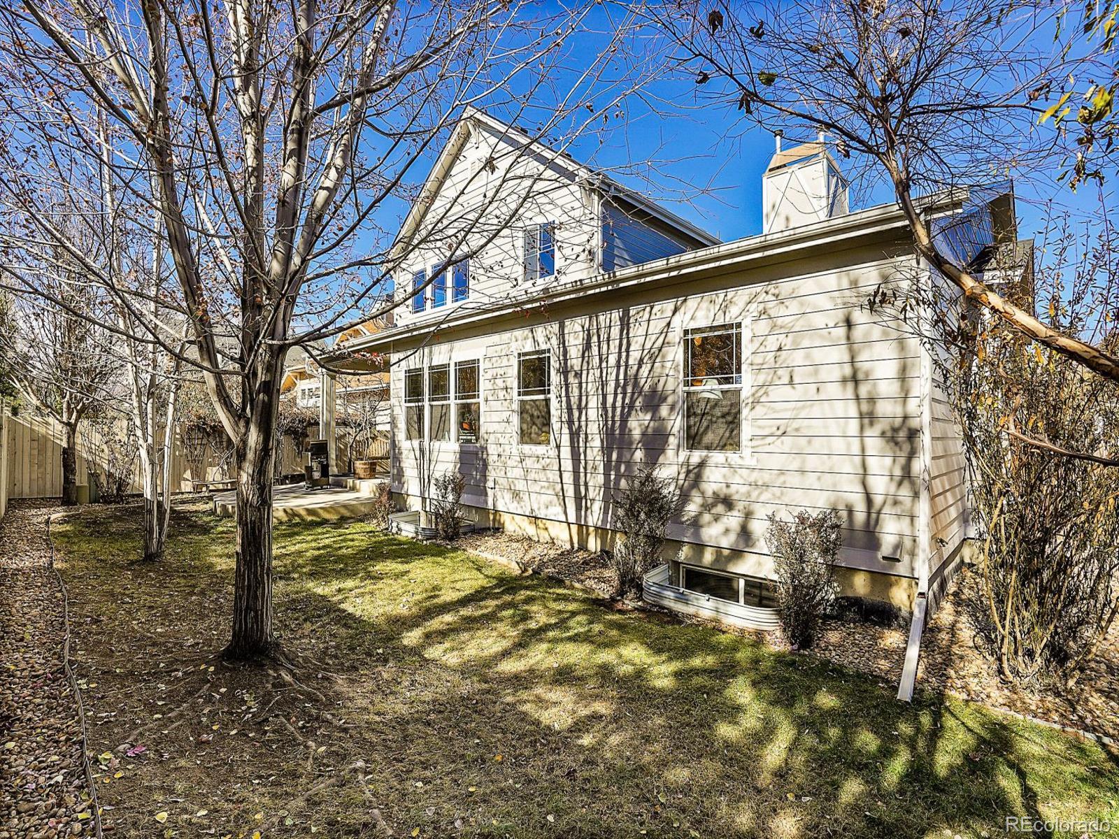 4207 Frederick Circle Longmont, CO 80503 - Photo 30 of 35 a view of a house with a large tree and a yard