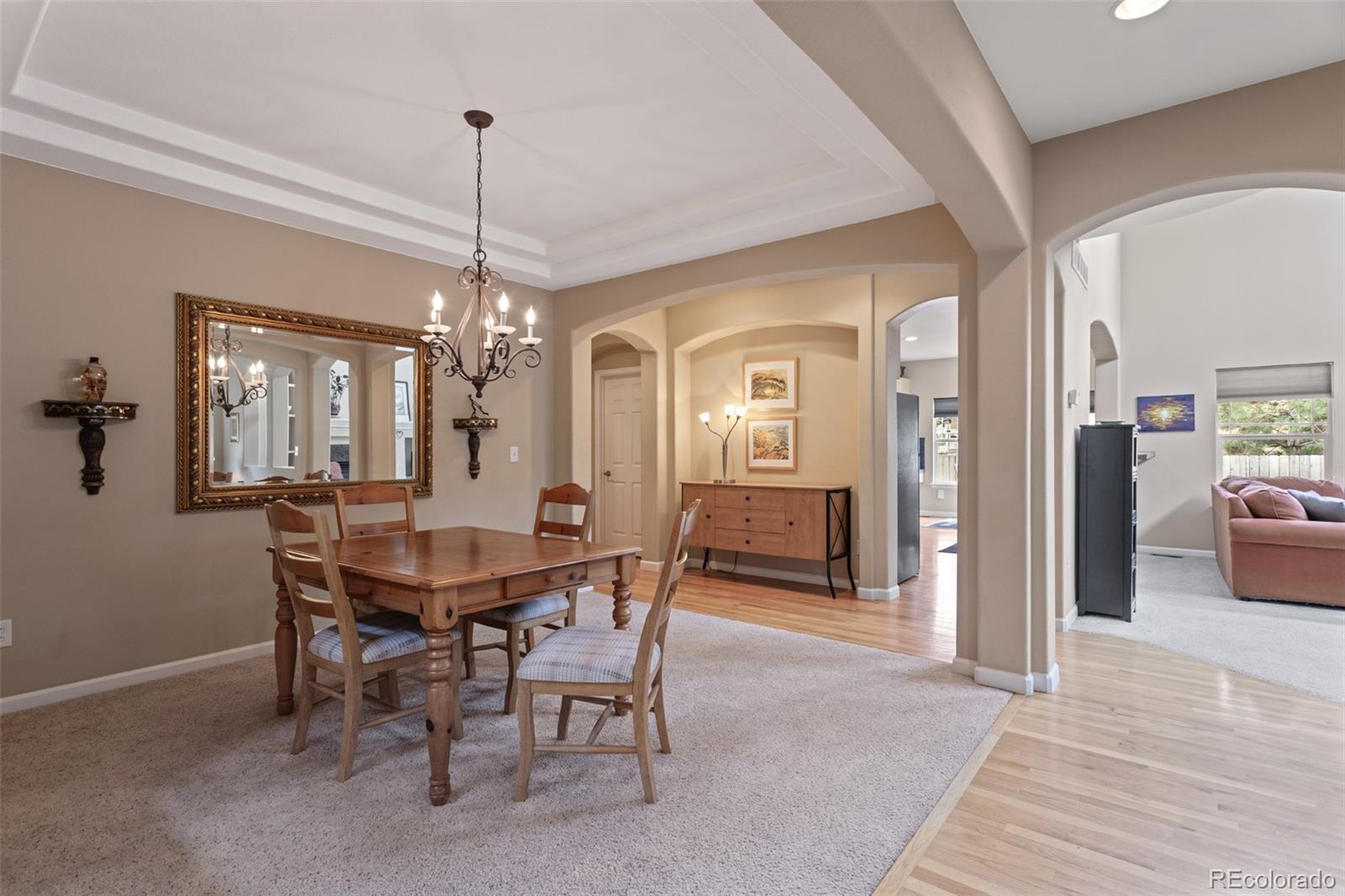 4207 Frederick Circle Longmont, CO 80503 - Photo 5 of 35 a dining room with furniture a chandelier and wooden floor