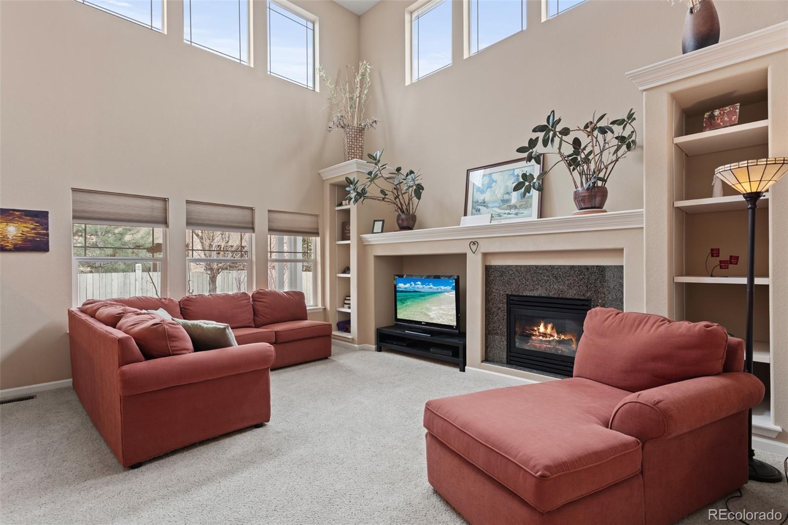 4207 Frederick Circle Longmont, CO 80503 - Photo 7 of 35 a living room with furniture and a fireplace