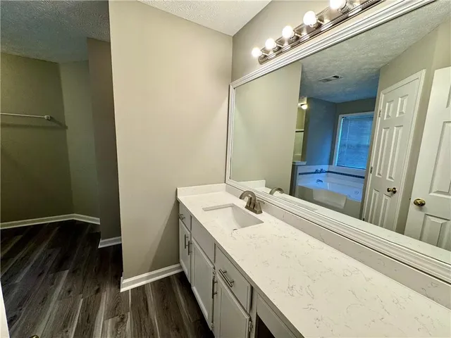 a bathroom with a tub and shower