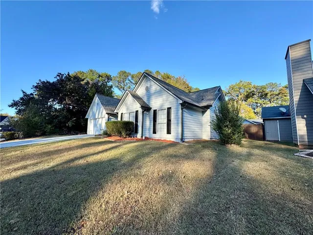 a view of an empty room with window and fireplace