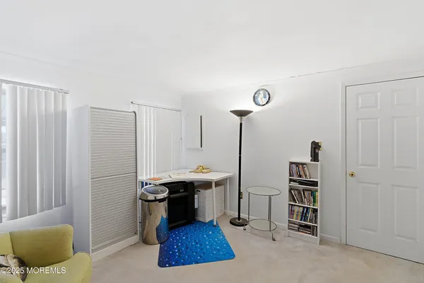 a living room with furniture a rug and a window