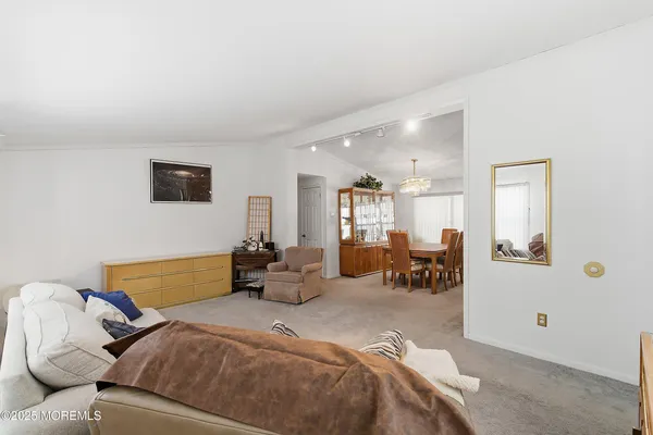 a bedroom with furniture and a large window