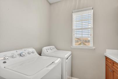 714 West Riviera Lane Clovis, CA 93619 - Photo 25 of 35 Indoor utility room with extra cabinets and counter top ,washer and dryer stay