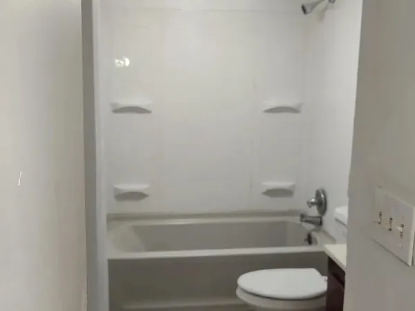 a bathroom with a toilet and a shower