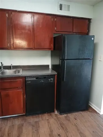 a kitchen with a refrigerator and cabinets