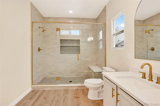 a bathroom with a sink a toilet and shower