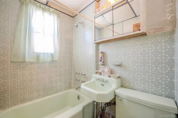 a bathroom with a sink a toilet and bathtub