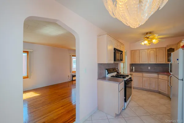 a kitchen with granite countertop stainless steel appliances and wooden cabinets