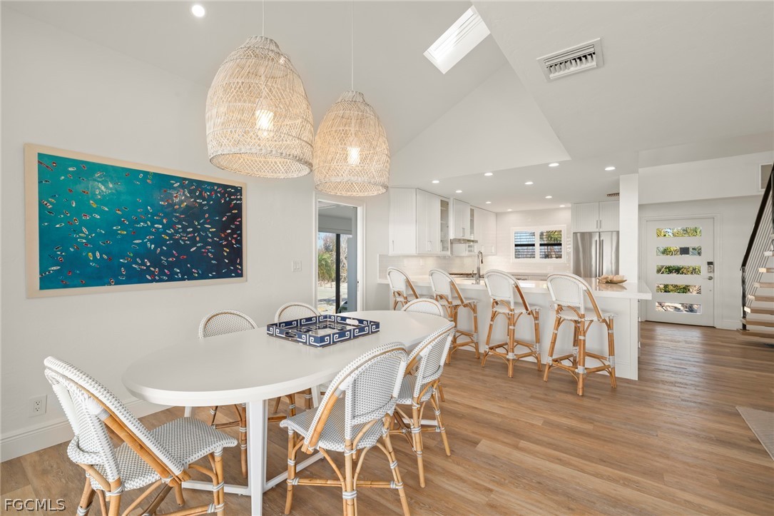19 Beach Homes Captiva, FL 33924 - Photo 13 of 49 a view of a dining room with furniture wooden floor and chandelier