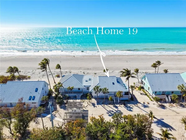 an aerial view of a house with a ocean view