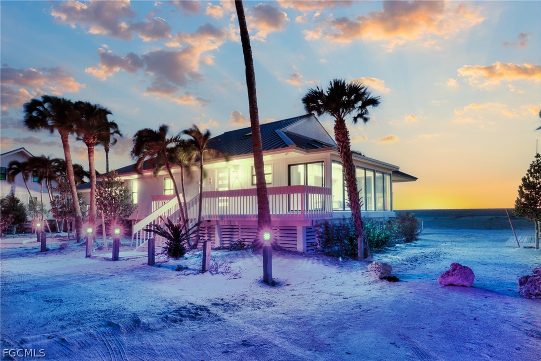 19 Beach Homes Captiva, FL 33924 - Photo 3 of 49 a backyard of a house with table and chairs