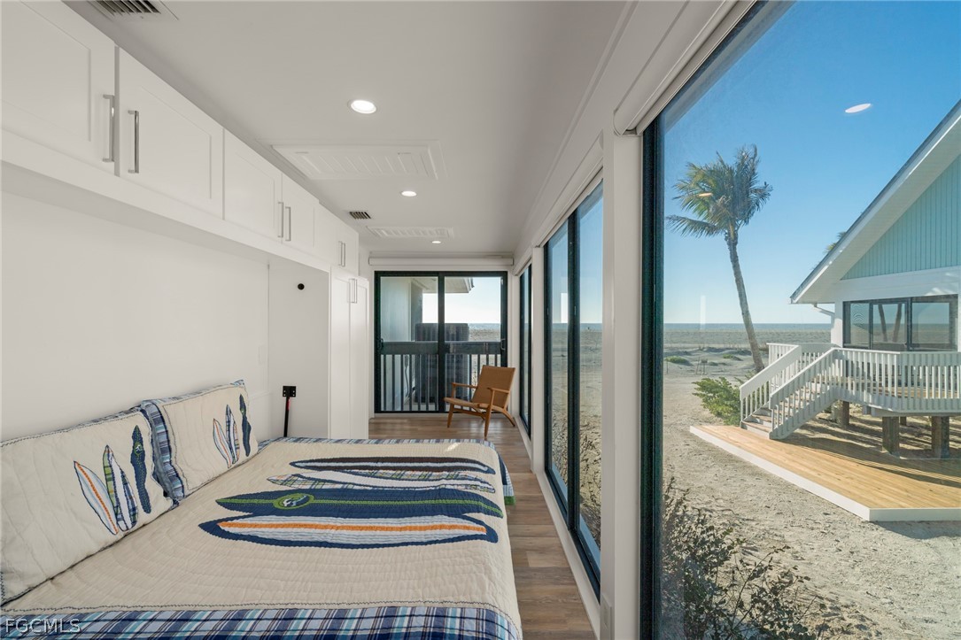 19 Beach Homes Captiva, FL 33924 - Photo 34 of 49 a bedroom with furniture and a floor to ceiling window