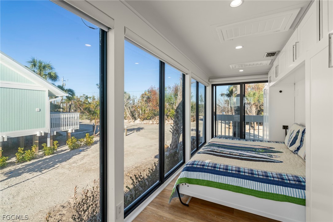 19 Beach Homes Captiva, FL 33924 - Photo 35 of 49 a bedroom with a bed and a large window