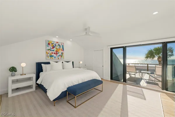 a bedroom with a bed and a large window with outer view